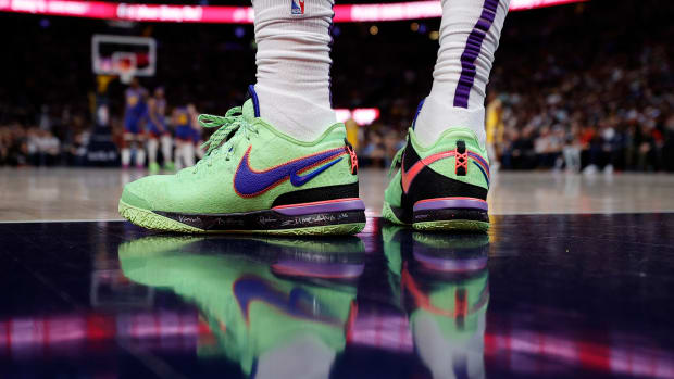 View of LeBron James' green and blue Nike shoes.